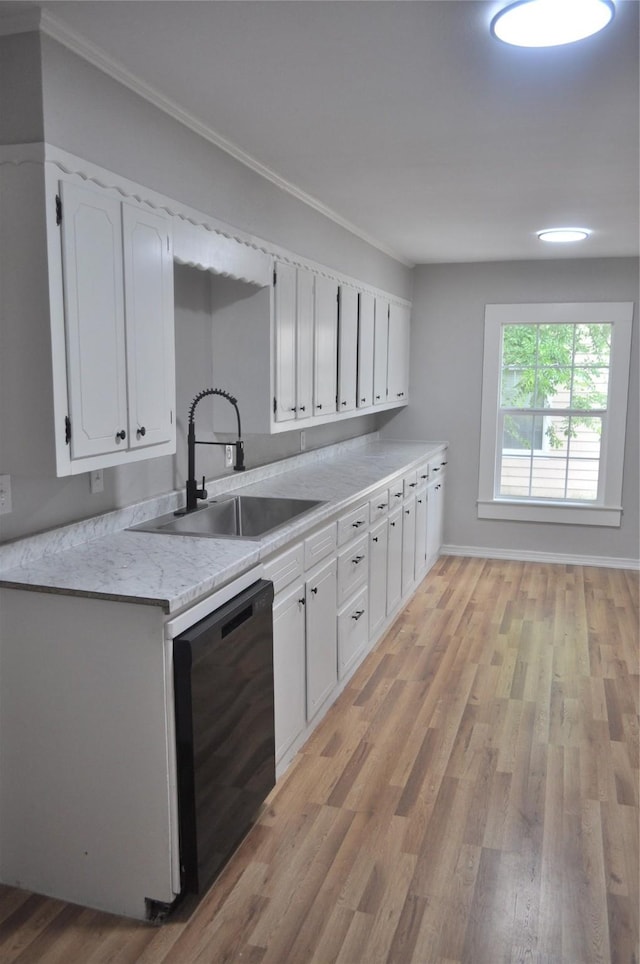 722 Sunset St, Sulphur Springs, TX 75482 - kitchen featuring dishwasher, a sink, light countertops, light wood finished floors, and white cabinets