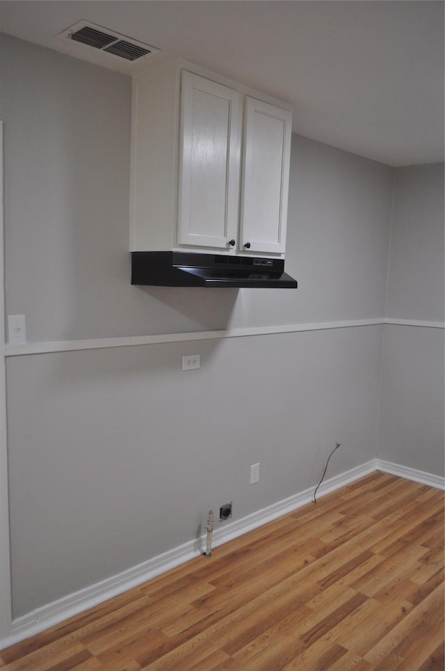 722 Sunset St, Sulphur Springs, TX 75482 - washroom with cabinet space, light wood-type flooring, gas dryer hookup, and baseboards