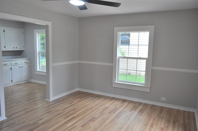 722 Sunset St, Sulphur Springs, TX 75482 - unfurnished dining area with light wood-style flooring, a ceiling fan, and baseboards