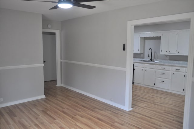 722 Sunset St, Sulphur Springs, TX 75482 - empty room with a sink, a ceiling fan, light wood-style floors, and baseboards