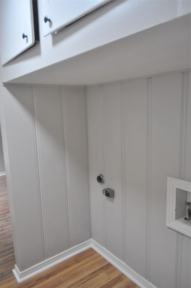 722 Sunset St, Sulphur Springs, TX 75482 - laundry room with a decorative wall and wood finished floors