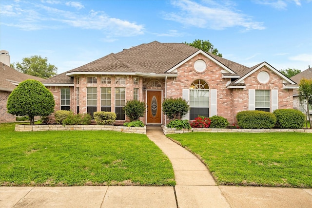 8405 Circleview St, Rowlett, TX 75088 - view of front facade with brick siding, roof with shingles, and a front lawn