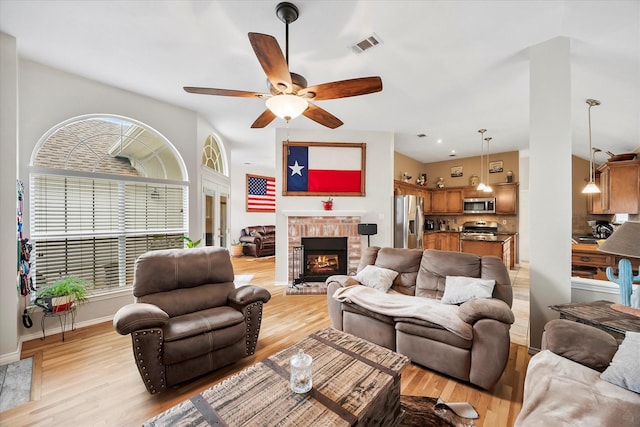 8405 Circleview St, Rowlett, TX 75088 - living room with ceiling fan, light wood finished floors, a brick fireplace, and baseboards