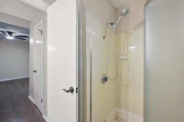 2009 Botts Dr, Arlington, TX 76012 - bathroom featuring a stall shower, wood finished floors, and baseboards