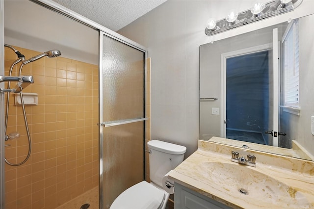 2009 Botts Dr, Arlington, TX 76012 - full bath with a stall shower, vanity, toilet, and a textured ceiling