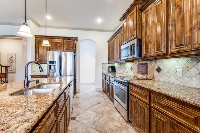 1420 Candler Dr, Prosper, TX 75078 - kitchen featuring arched walkways, stainless steel appliances, a sink, light stone countertops, and ornamental molding