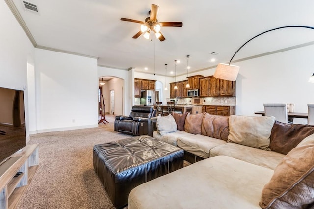 1420 Candler Dr, Prosper, TX 75078 - living room with arched walkways, ceiling fan, light carpet, crown molding, and baseboards