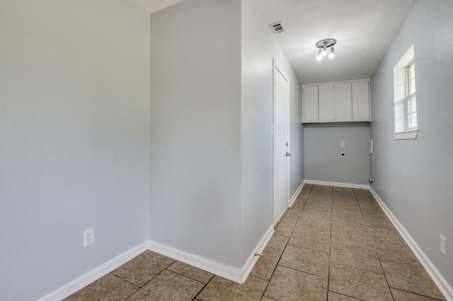 204 E Willow Ln, Princeton, TX 75407 - washroom featuring cabinet space, light tile patterned floors, baseboards, and hookup for an electric dryer