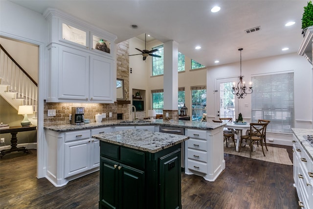 2219 Graystone Ct, Keller, TX 76248 - kitchen with a sink, dark wood-style floors, a ceiling fan, a peninsula, and white cabinets