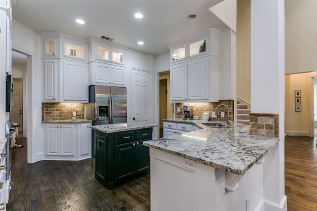 2219 Graystone Ct, Keller, TX 76248 - kitchen featuring stainless steel fridge, a sink, a peninsula, tasteful backsplash, and dark wood-style floors