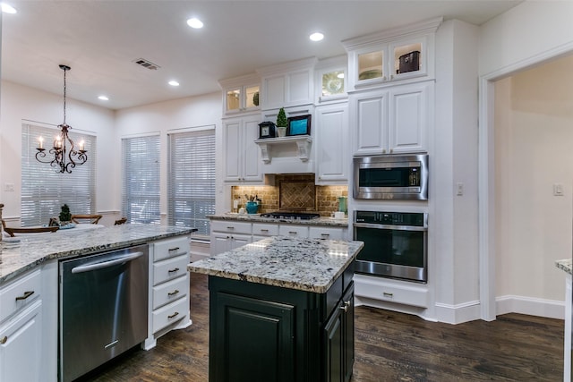2219 Graystone Ct, Keller, TX 76248 - kitchen with stainless steel appliances, white cabinets, dark wood-style floors, backsplash, and a chandelier