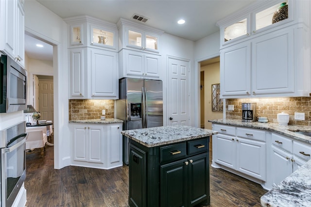 2219 Graystone Ct, Keller, TX 76248 - kitchen featuring stainless steel appliances, white cabinetry, tasteful backsplash, dark wood-type flooring, and recessed lighting