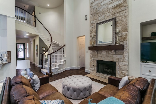 2219 Graystone Ct, Keller, TX 76248 - living area with stairway, wood finished floors, a fireplace, baseboards, and a towering ceiling