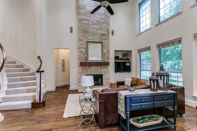 2219 Graystone Ct, Keller, TX 76248 - living room featuring a high ceiling, a ceiling fan, wood finished floors, a fireplace, and baseboards