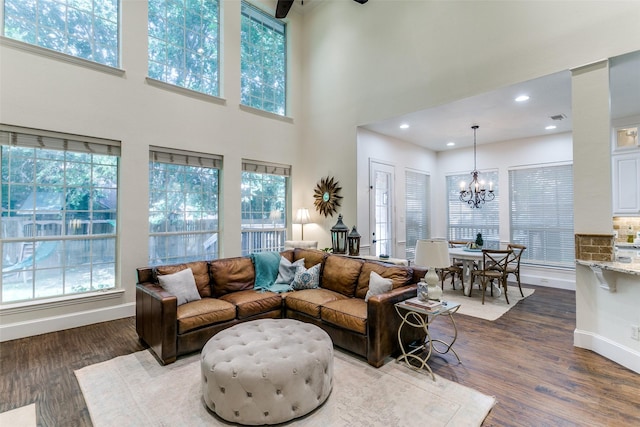 2219 Graystone Ct, Keller, TX 76248 - living room with healthy amount of natural light, a chandelier, wood finished floors, a high ceiling, and recessed lighting