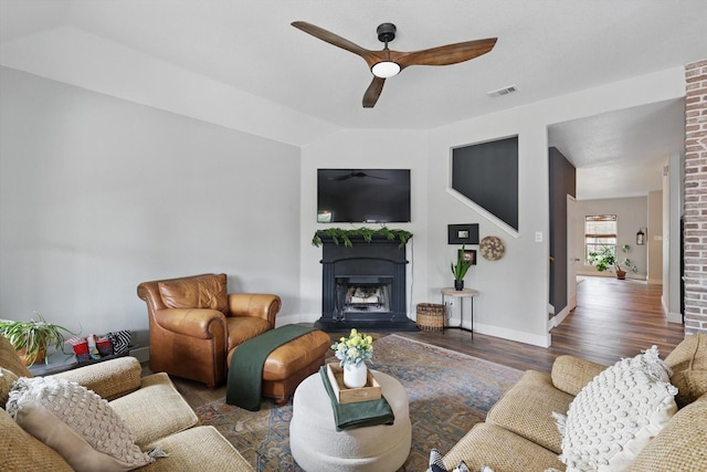 3964 Hunter Peak Rd, Fort Worth, TX 76262 - living area featuring ceiling fan, wood finished floors, a fireplace with raised hearth, and baseboards