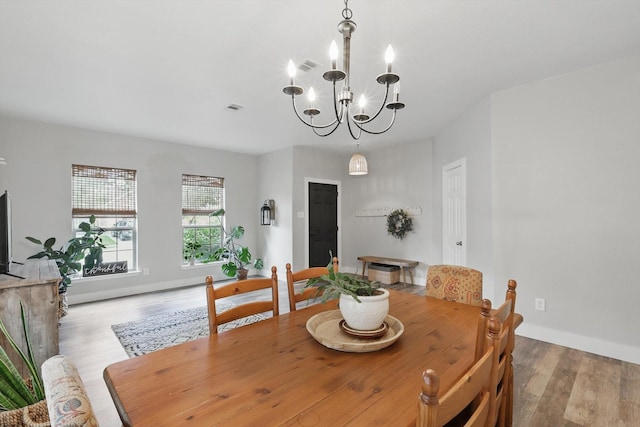 3964 Hunter Peak Rd, Fort Worth, TX 76262 - dining space featuring a chandelier, wood finished floors, and baseboards
