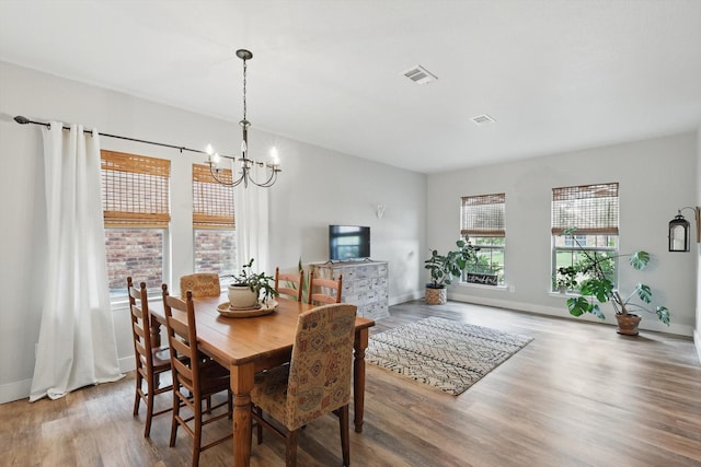 3964 Hunter Peak Rd, Fort Worth, TX 76262 - dining room with wood finished floors, a chandelier, and baseboards