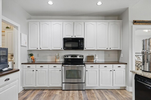 3964 Hunter Peak Rd, Fort Worth, TX 76262 - kitchen featuring black appliances, dark countertops, white cabinets, and recessed lighting