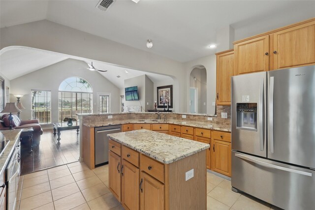 110 Lakeshore Dr, Trophy Club, TX 76262 - kitchen with appliances with stainless steel finishes, vaulted ceiling, a peninsula, open floor plan, and a sink