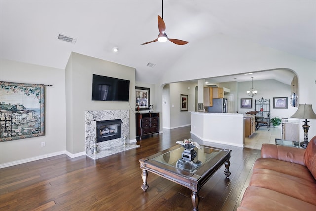 110 Lakeshore Dr, Trophy Club, TX 76262 - living room with arched walkways, a ceiling fan, a fireplace, wood finished floors, and a chandelier