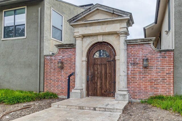5816 Birchbrook Dr Unit 118, Dallas, TX 75206 - doorway to property with stucco siding and brick siding