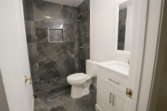 706 Midway Dr W, Euless, TX 76039 - full bath with marble look tile flooring, a tile shower, vanity, and toilet