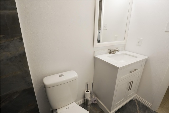 706 Midway Dr W, Euless, TX 76039 - bathroom featuring vanity, toilet, and baseboards