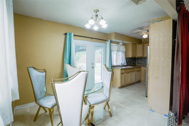 706 Midway Dr W, Euless, TX 76039 - dining space featuring a chandelier, a textured ceiling, french doors, and a ceiling fan