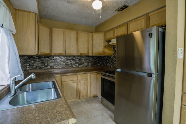 706 Midway Dr W, Euless, TX 76039 - kitchen with stainless steel appliances, a sink, tasteful backsplash, light brown cabinetry, and a textured ceiling