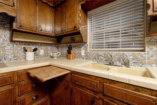 3410 Ellis Ave, Fort Worth, TX 76106 - kitchen featuring backsplash and brown cabinetry