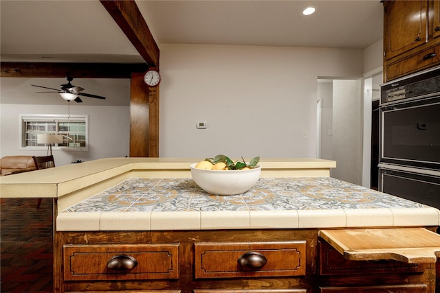 3410 Ellis Ave, Fort Worth, TX 76106 - kitchen with ceiling fan, tile countertops, recessed lighting, open floor plan, and brown cabinetry