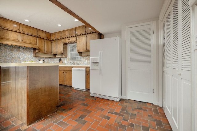 3410 Ellis Ave, Fort Worth, TX 76106 - kitchen featuring white appliances, light countertops, recessed lighting, brick flooring, and brown cabinets