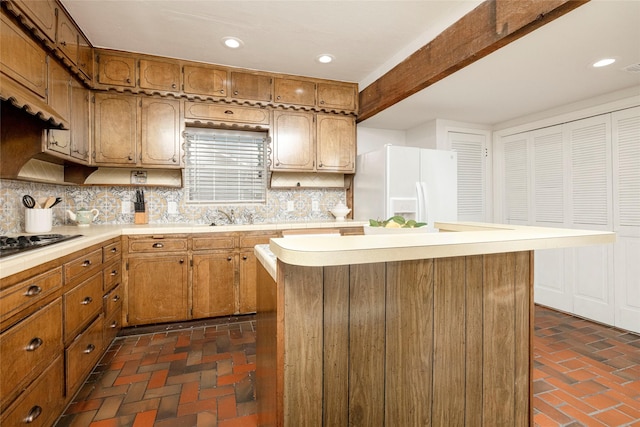 3410 Ellis Ave, Fort Worth, TX 76106 - kitchen featuring white refrigerator with ice dispenser, brick flooring, backsplash, light countertops, and recessed lighting