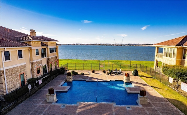 2132 Portofino Dr, Rockwall, TX 75032 - community pool with a water view, a fenced backyard, and a patio area