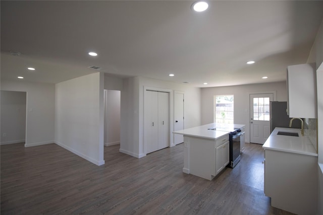 10734 Coogan Dr, Dallas, TX 75229 - kitchen with a sink, electric range, light countertops, recessed lighting, and dark wood finished floors