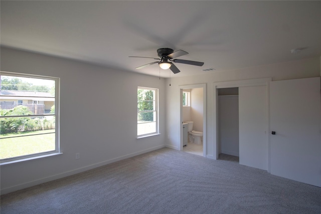 10734 Coogan Dr, Dallas, TX 75229 - unfurnished bedroom featuring light colored carpet, ensuite bathroom, baseboards, a closet, and ceiling fan