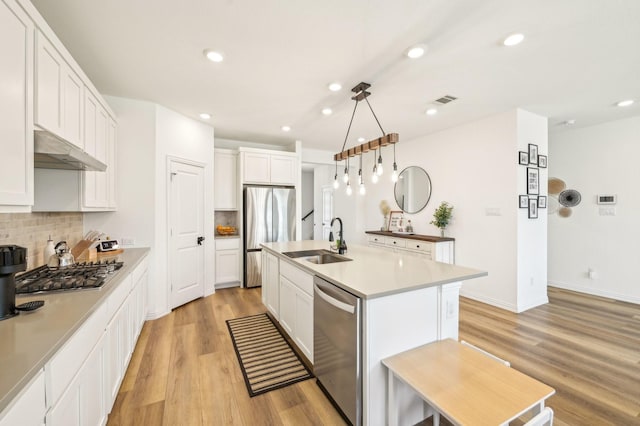 1213 Palmetto Dr, Forney, TX 75126 - kitchen featuring a sink, under cabinet range hood, stainless steel appliances, backsplash, and recessed lighting