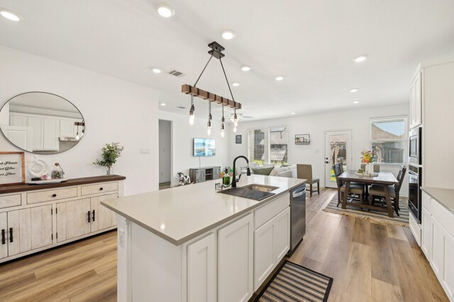 1213 Palmetto Dr, Forney, TX 75126 - kitchen with a sink, stainless steel appliances, light wood finished floors, recessed lighting, and a kitchen island with sink