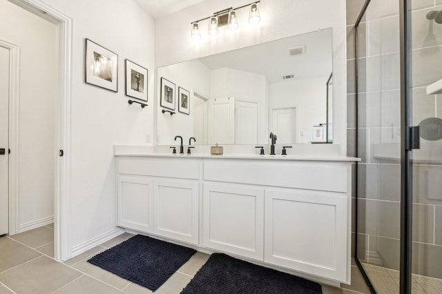 1213 Palmetto Dr, Forney, TX 75126 - bathroom with double vanity, tile patterned floors, a tile shower, and baseboards