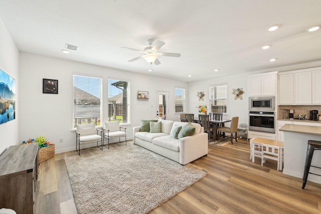 1213 Palmetto Dr, Forney, TX 75126 - living area with a ceiling fan, light wood finished floors, recessed lighting, and baseboards