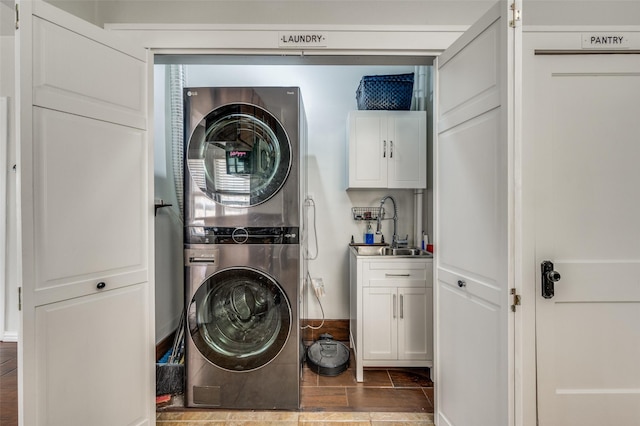 1833 Mcmillan Ave, Dallas, TX 75206 - laundry area with stacked washer and clothes dryer and cabinet space