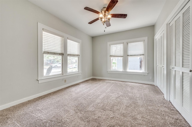 1833 Mcmillan Ave, Dallas, TX 75206 - unfurnished bedroom with carpet floors, baseboards, ceiling fan, and two closets