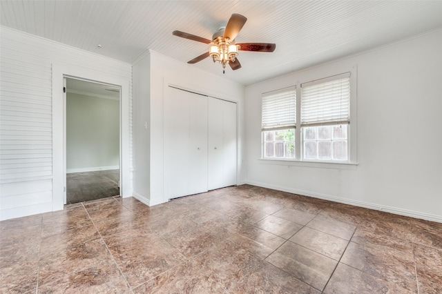 1833 Mcmillan Ave, Dallas, TX 75206 - unfurnished bedroom featuring a closet, crown molding, a ceiling fan, baseboards, and tile patterned floors