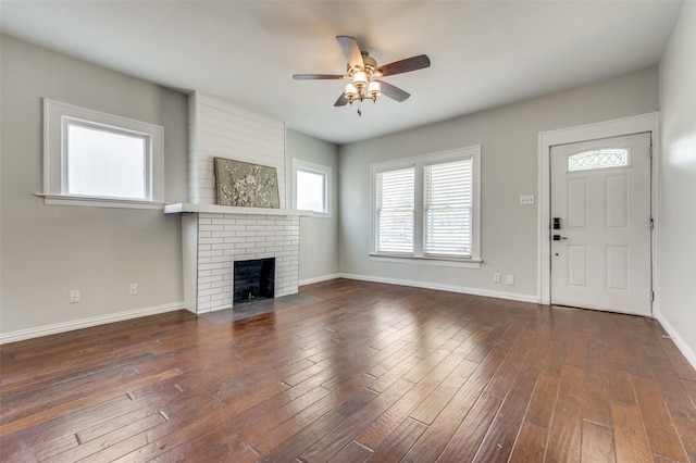 1833 Mcmillan Ave, Dallas, TX 75206 - unfurnished living room with ceiling fan, a brick fireplace, baseboards, and hardwood / wood-style floors