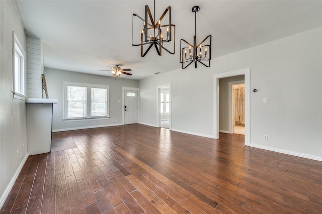 1833 Mcmillan Ave, Dallas, TX 75206 - unfurnished living room featuring a chandelier, a ceiling fan, baseboards, and wood finished floors