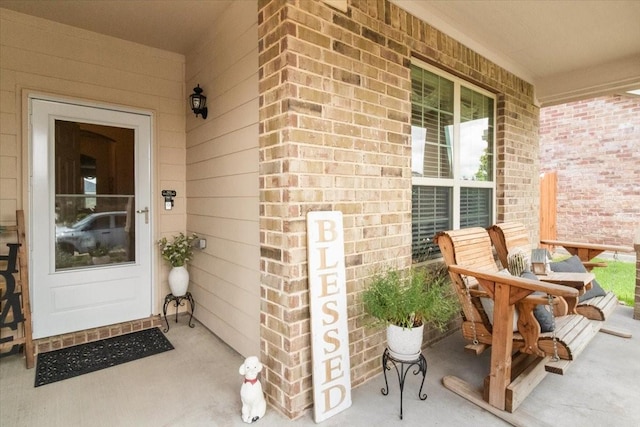 2113 Brenham Dr, Forney, TX 75126 - doorway to property featuring a porch and brick siding