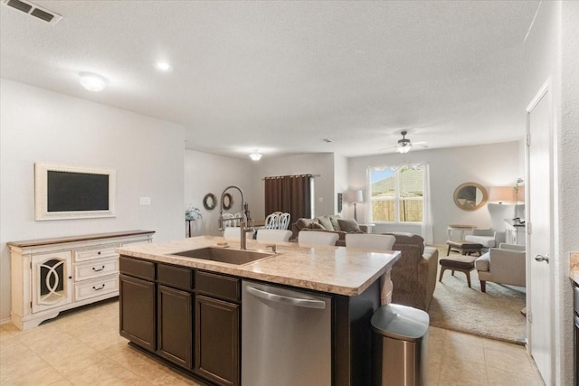 2113 Brenham Dr, Forney, TX 75126 - kitchen featuring stainless steel dishwasher, a sink, dark brown cabinetry, light countertops, and ceiling fan