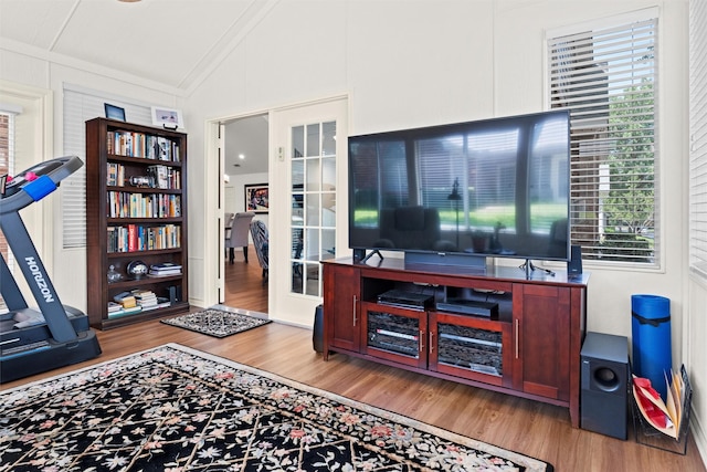 908 Bridges Dr, Arlington, TX 76012 - living area featuring vaulted ceiling, wood finished floors, healthy amount of natural light, and french doors