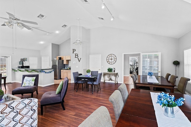 908 Bridges Dr, Arlington, TX 76012 - dining space with rail lighting, ceiling fan, dark wood-style flooring, high vaulted ceiling, and baseboards